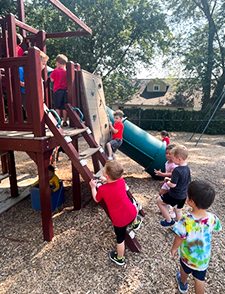 Children playing together on the playground at Stepping Stones Child Care